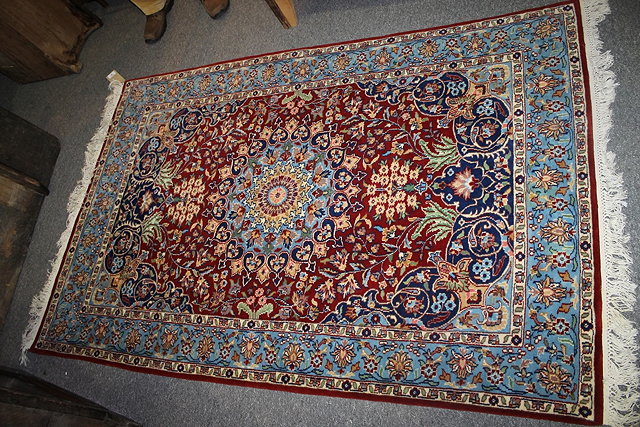 Appraisal: A PERSIAN STYLE BLUE GROUND RUG with central panel with