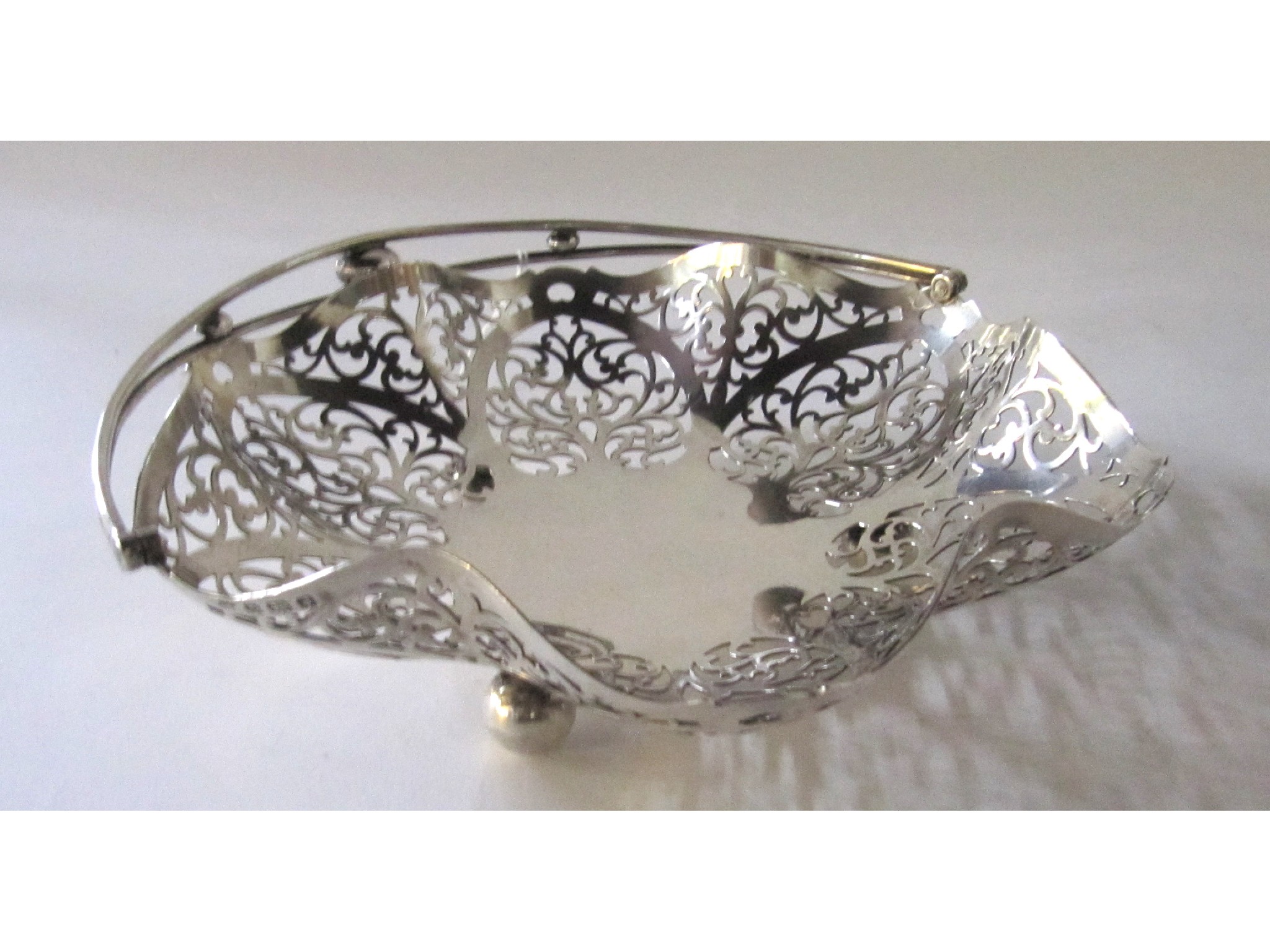 Appraisal: A silver swing handled cake basket Birmingham