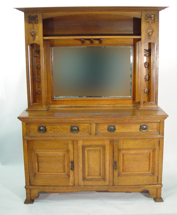 Appraisal: Art Nouveau oak dresser with bevelled mirror back flanked by