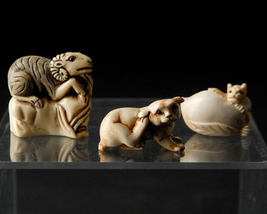 Appraisal: Three Carved Ivory Netsukes a dog bear with a peach