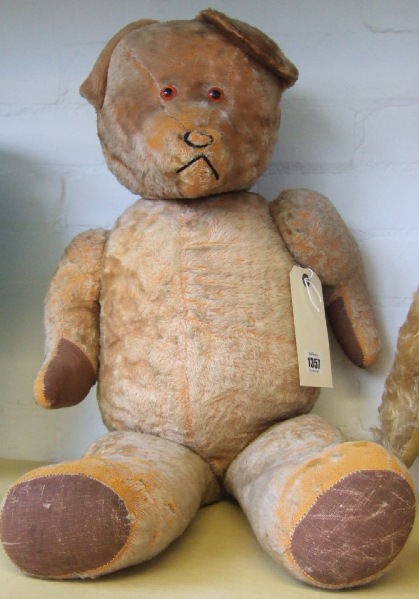 Appraisal: A golden haired teddy bear mid th century with orange