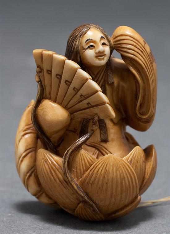 Appraisal: Japanese carved ivory netsuke Goddess standing in a lotus flower