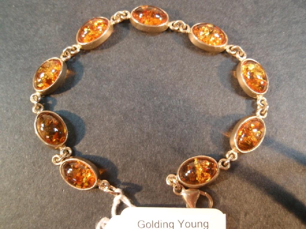 Appraisal: A bracelet of amber coloured cabachon set in yellow metal