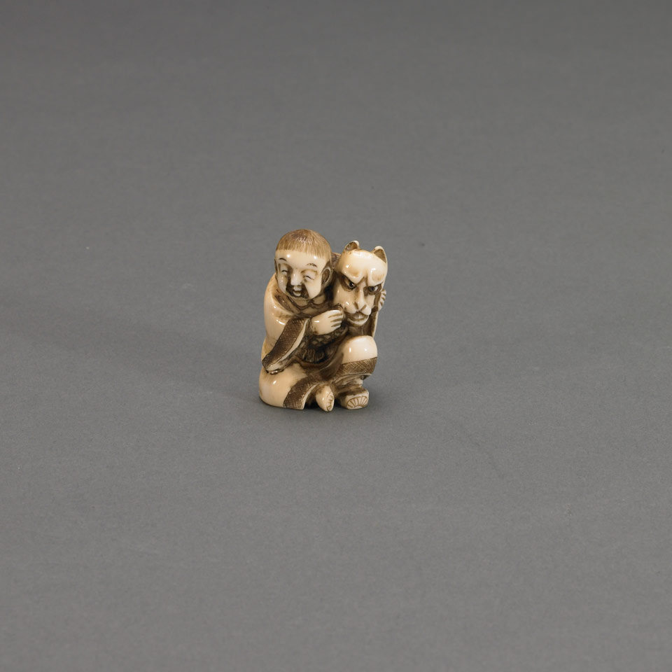 Appraisal: Ivory Netsuke of a Boy with a Kitsune Mask Japan