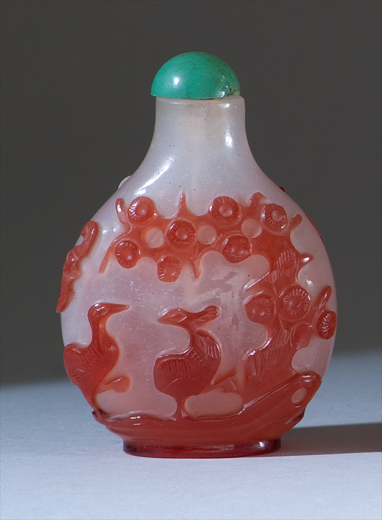 Appraisal: OVERLAY GLASS SNUFF BOTTLE th CenturyIn pear shape With deer