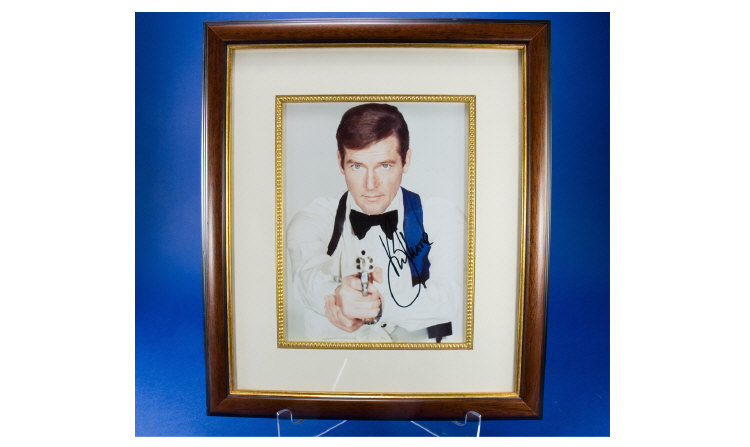 Appraisal: Framed Colour Photo of Roger Moore signed measures by inches