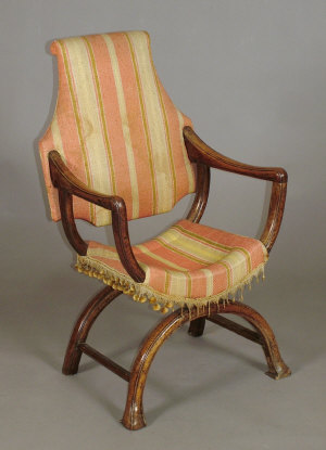 Appraisal: A walnut X-frame open armchair th century with upholstered back