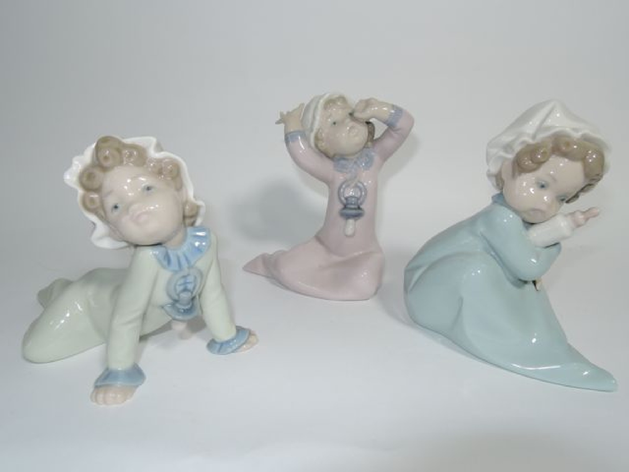 Appraisal: A set of three Lladro figures of babies Crawling Crying