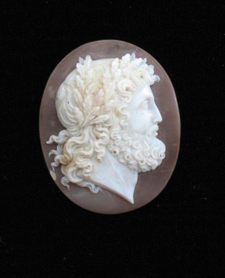 Appraisal: A CAMEO of curved oval form depicting a side portrait