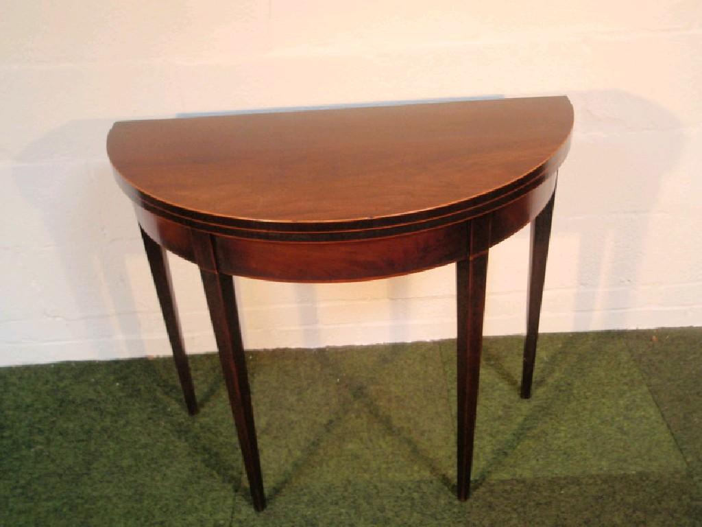 Appraisal: A Sheraton mahogany demi-lune card table with folding top and