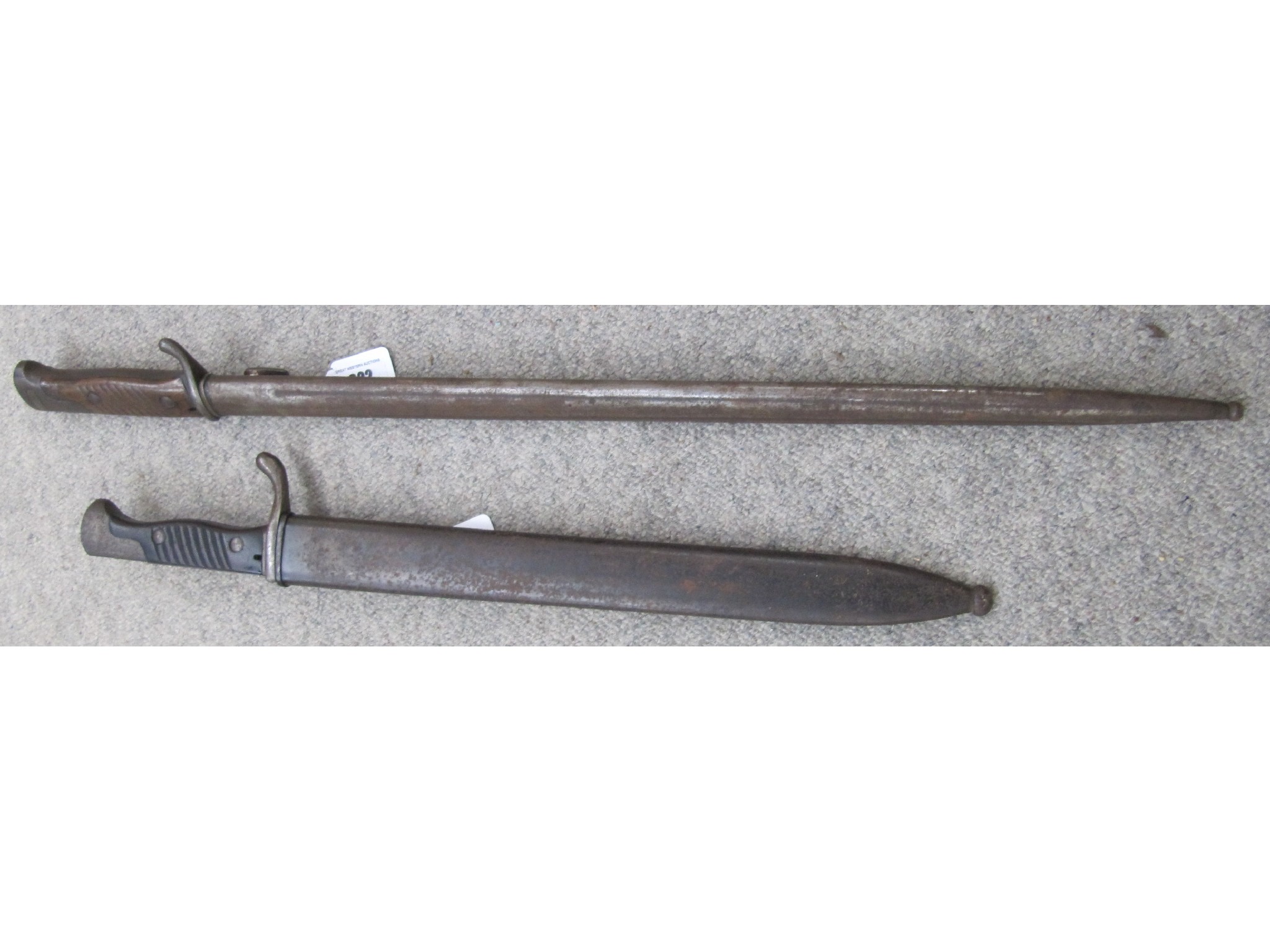 Appraisal: A lot comprising two German WWI bayonets in scabbard