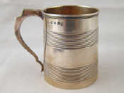 Appraisal: A Georgian silver mug with ribbed bands Samuel Knight London