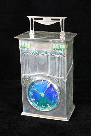 Appraisal: An enamelled silver table clock The Magnus by Archibald Knox