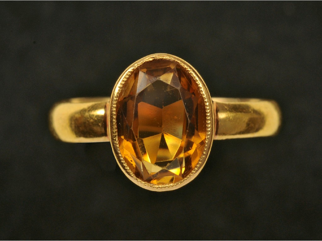 Appraisal: A Citrine Dress Ring the oval-cut stone rub-over set in