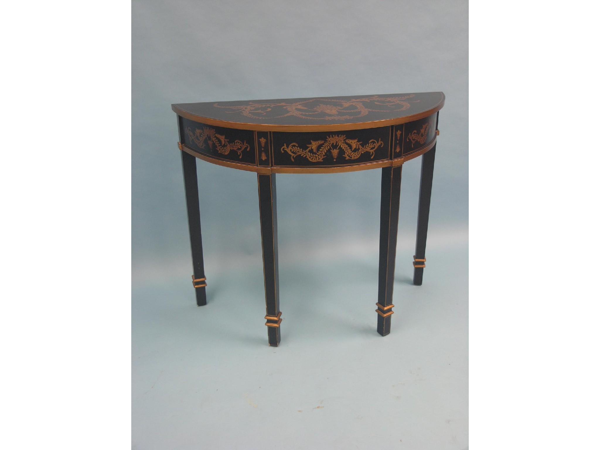 Appraisal: A neo-classical style hall table gilded with leaf-scrolls against a