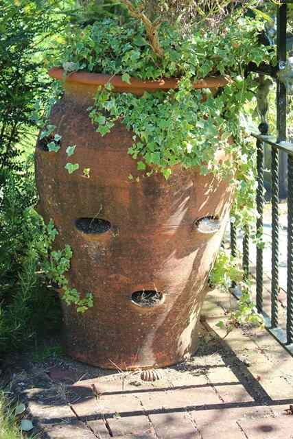 Appraisal: A PAIR OF TALL WHICHFORD POTTERY TERRACOTTA STRAWBERRY PLANTERS each