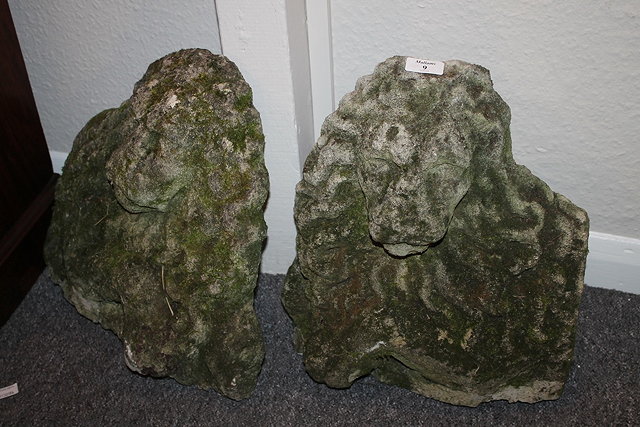 Appraisal: A NEAR PAIR OF RECONSTITUTED STONE FACINGS OF LIONS