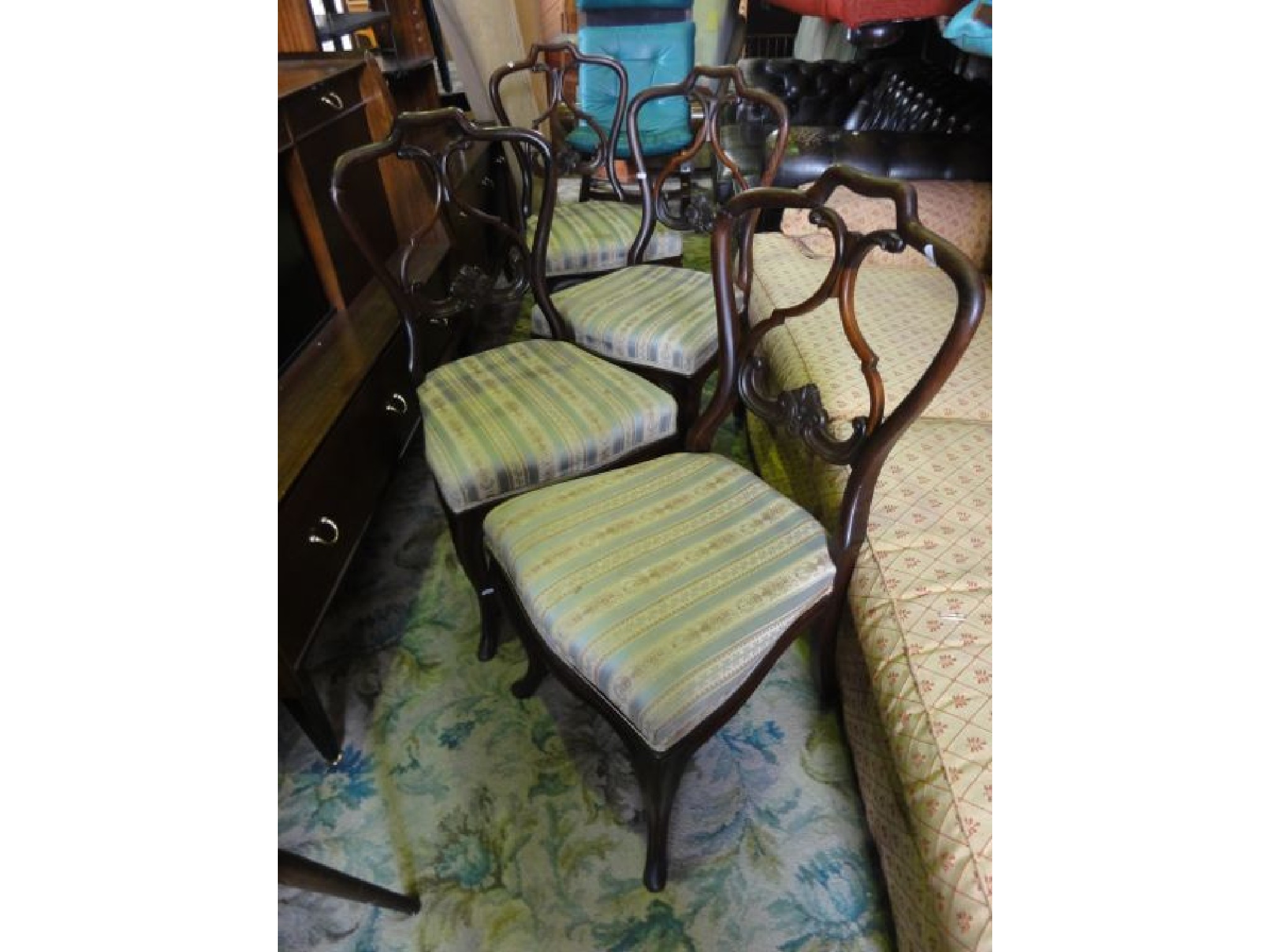 Appraisal: A set of four Victorian rosewood balloon back dining chairs