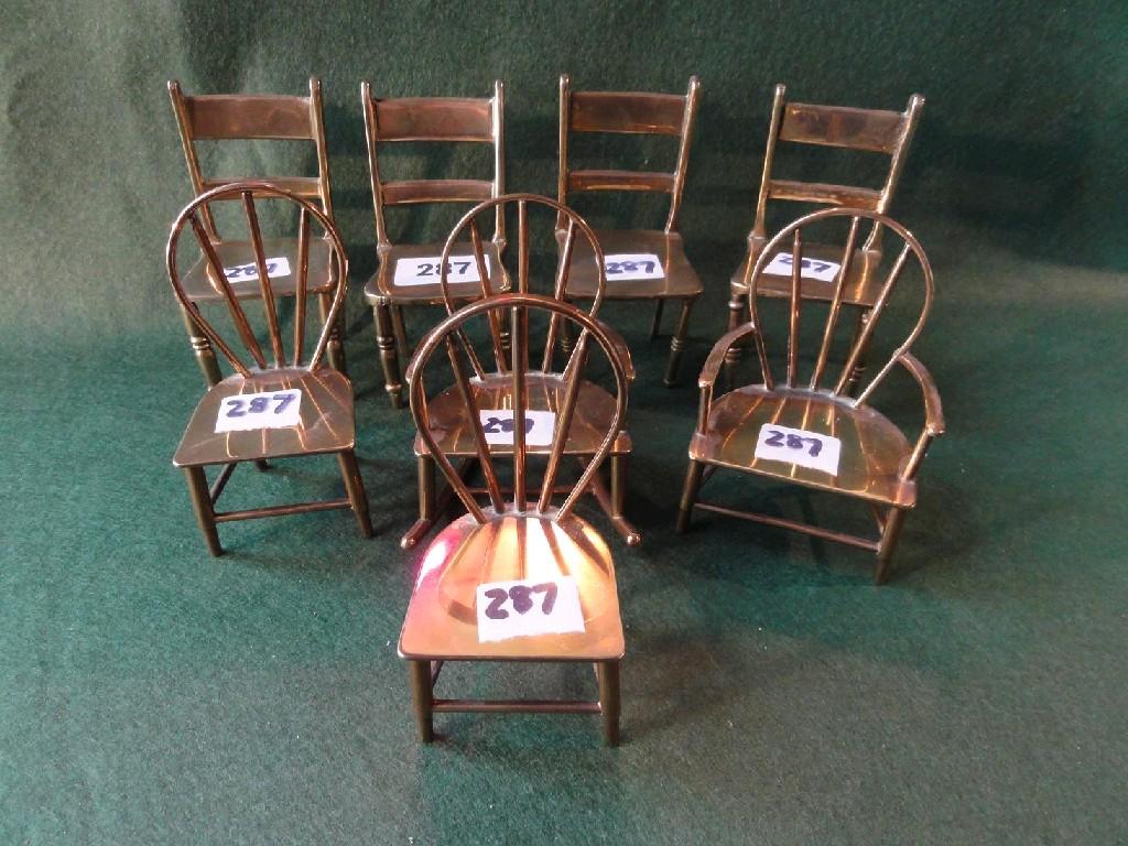 Appraisal: A collection of eight various miniature brass kitchen chairs some