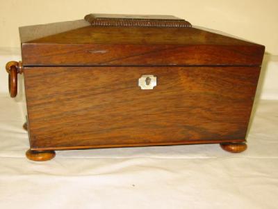 Appraisal: A ROSEWOOD TEA CADDY of sarcophagus form the hinged lid