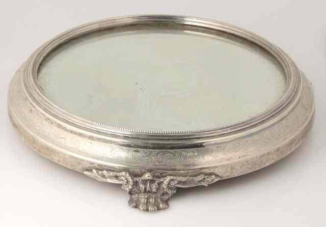 Appraisal: An electroplated cake stand with mirrored surface on winged lion