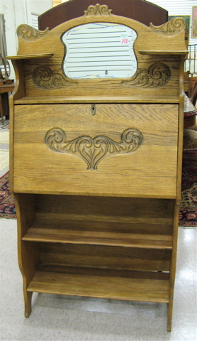 Appraisal: AN OAK SLANT-FRONT SECRETARY BOOKCASE American c the carved top