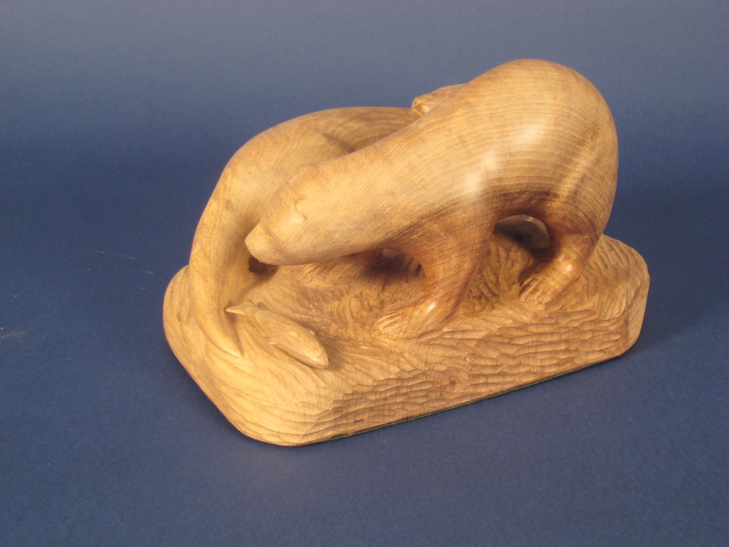 Appraisal: A carved walnut Group of two Otters