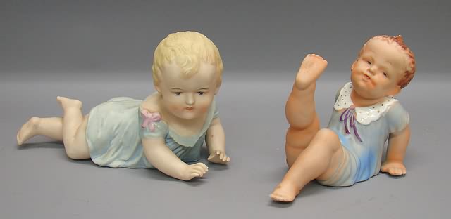 Appraisal: Pair of male piano babies China baby leaning back L