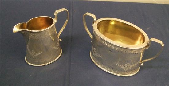 Appraisal: Victorian silver oval sugar basin and cream jug with engraved