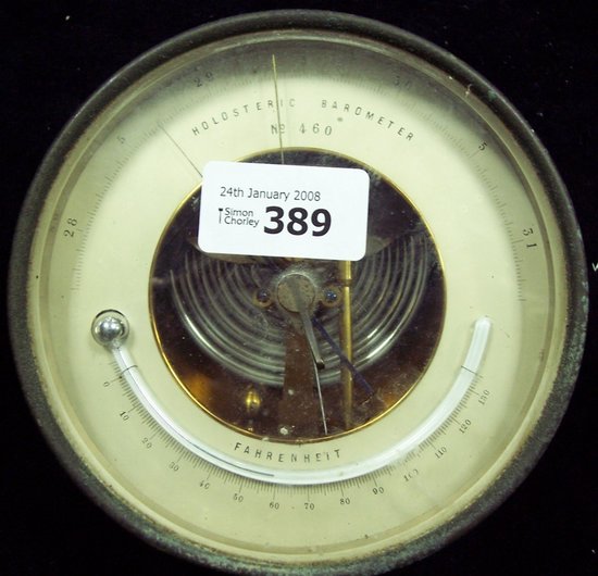 Appraisal: A circular aneroid barometer and thermometer in a brass case