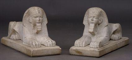 Appraisal: PAIR OF EGYPTIAN REVIVAL CARVED MARBLE SPHINXES Each rendered recumbent