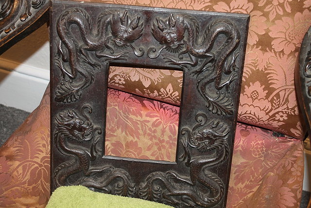 Appraisal: A CARVED CHINESE STYLE HARDWOOD FRAME with dragon designs cm