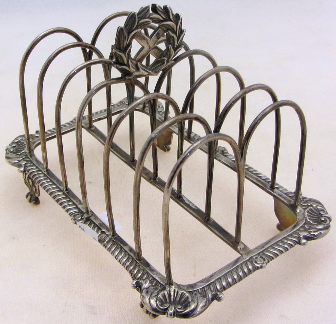 Appraisal: A silver seven bar toastrack with a wreath shaped handle