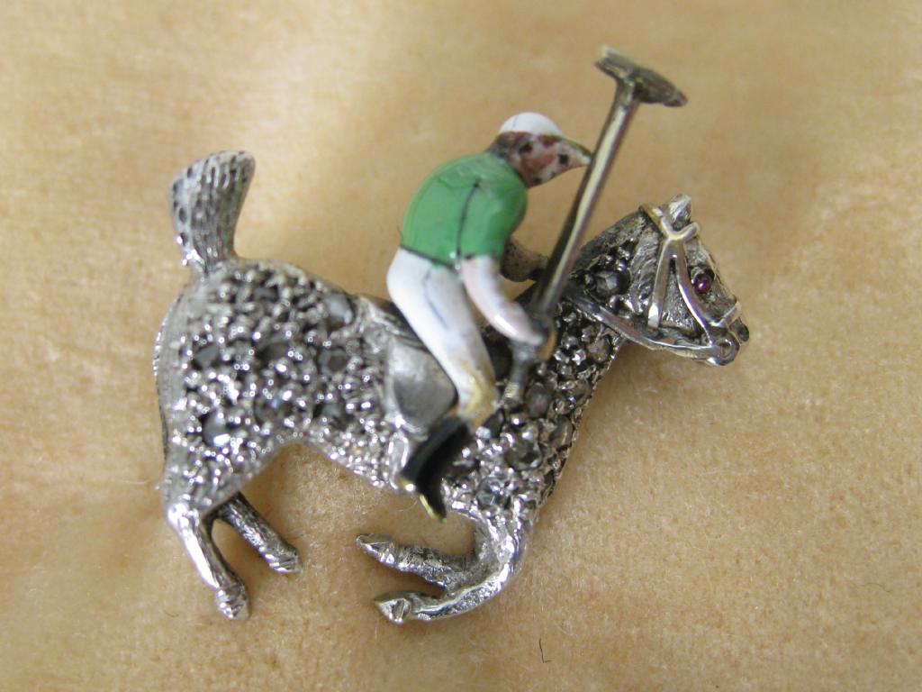 Appraisal: A Brooch in the form of Polo Player with enamelled