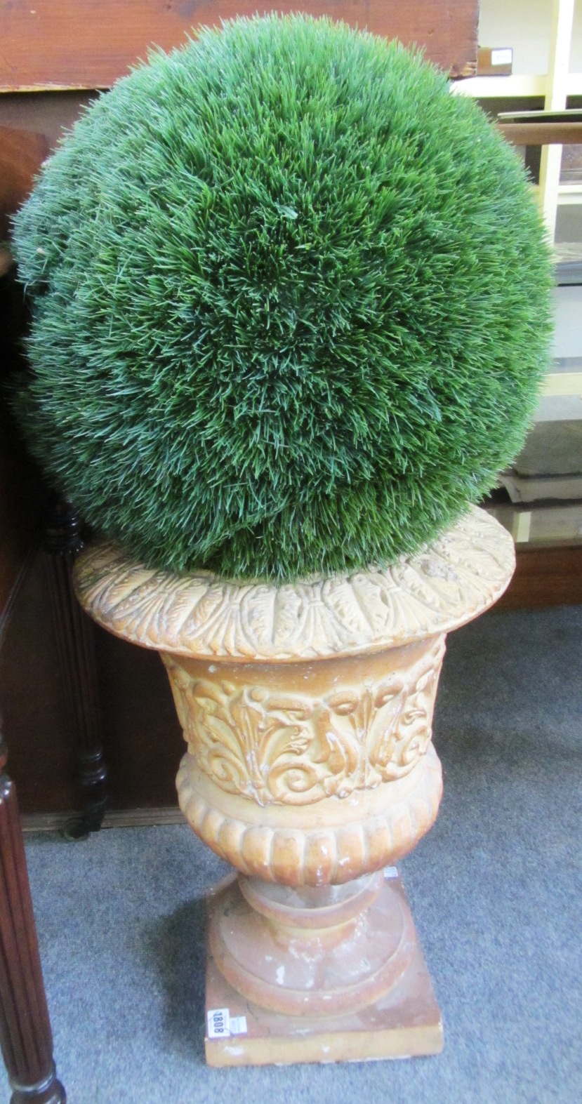 Appraisal: A pair of composite stone urns on turned socle and