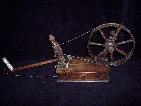 Appraisal: A table spinning wheel with turned flying shuttle and wheel