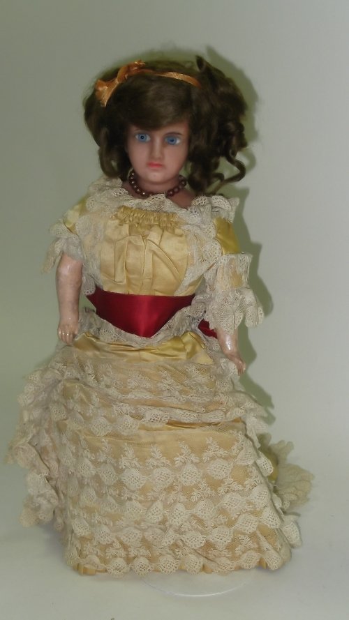 Appraisal: A wax head German doll with composition limbs and cloth