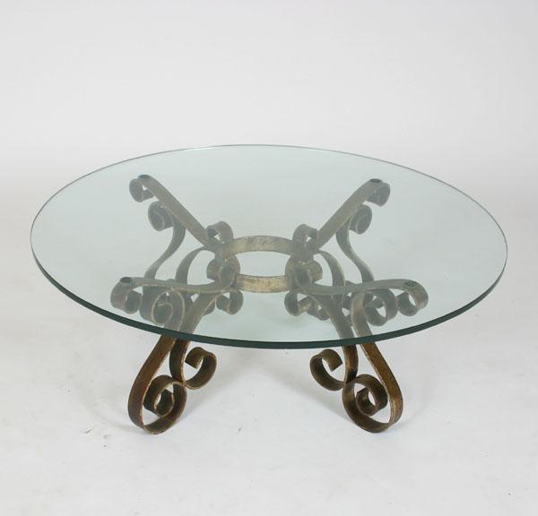 Appraisal: Iron glass top table with scrolling legs x small chips