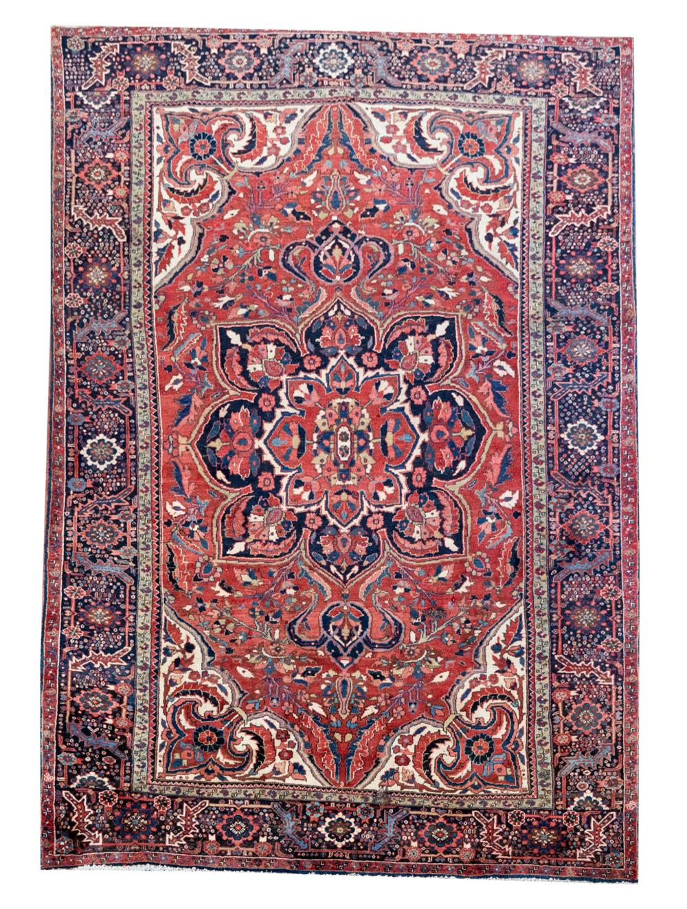 Appraisal: PERSIAN-STYLE RUGwool on cotton Condition two four inch-diameter areas of