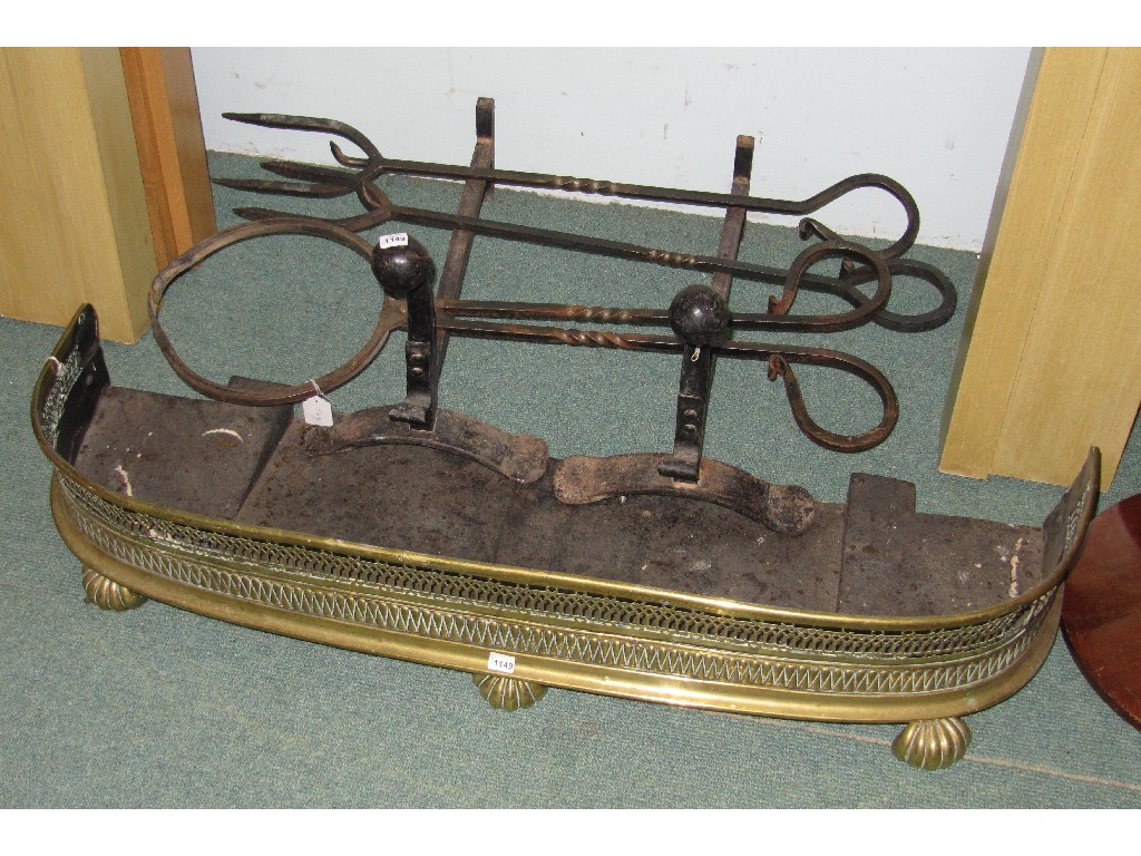 Appraisal: Victorian brass fender and fire dogs and fire irons