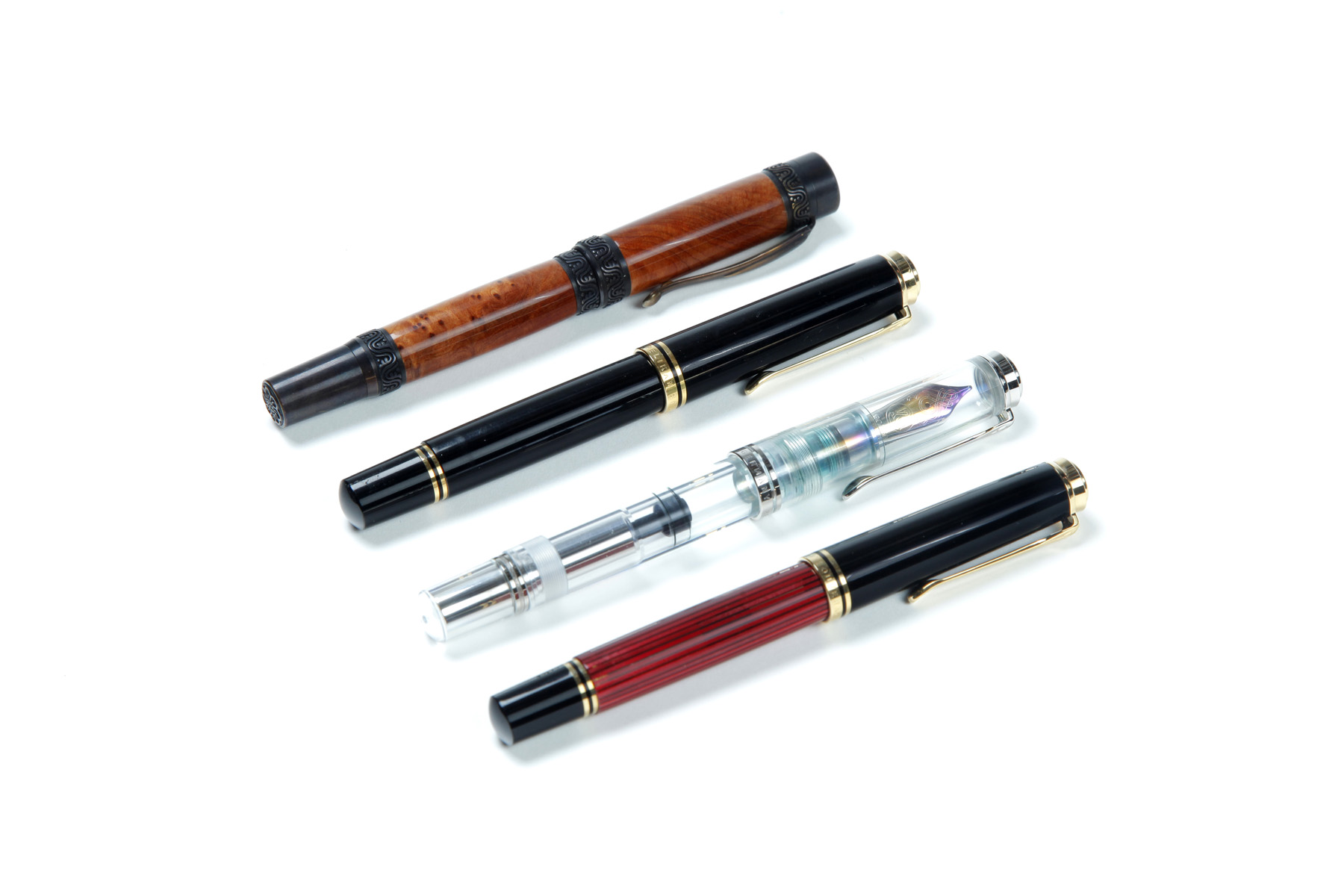 Appraisal: FOUR FOUNTAIN PENS Twentieth century Pelikan Demonstrator Pelikan Souveran Pelikan