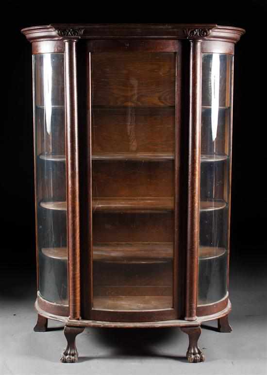 Appraisal: Victorian oak bow-front china cabinet late th century shaped glass