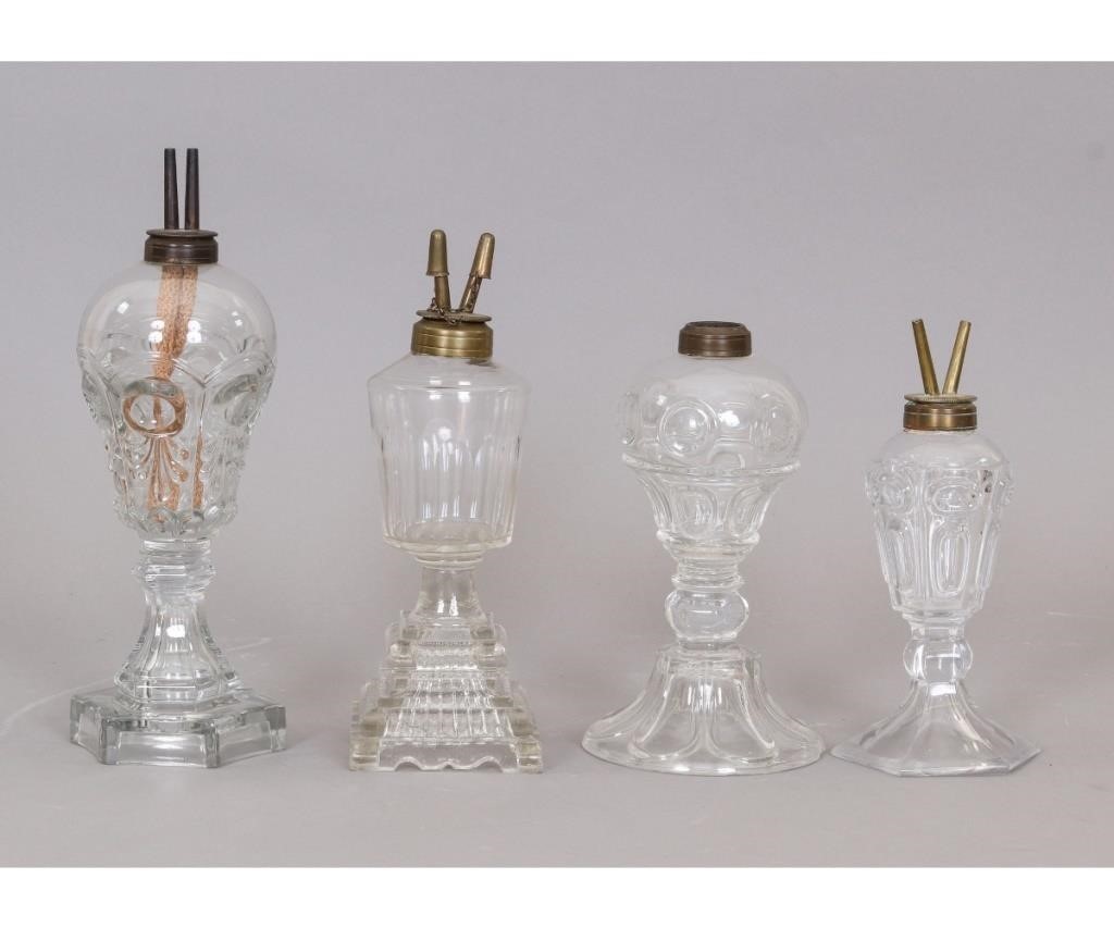 Appraisal: Four clear sandwich glass oil lamps late th c three