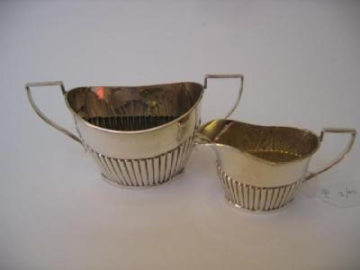 Appraisal: A GEORGE III STYLE SUGAR AND CREAM SET maker W