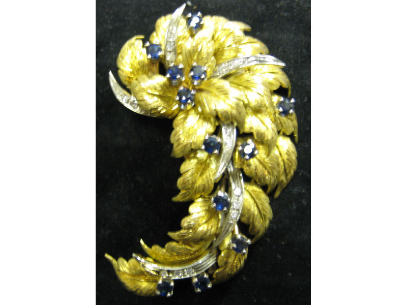 Appraisal: SAPPHIRE AND DIAMOND BROOCH k yellow gold brooch with leaf