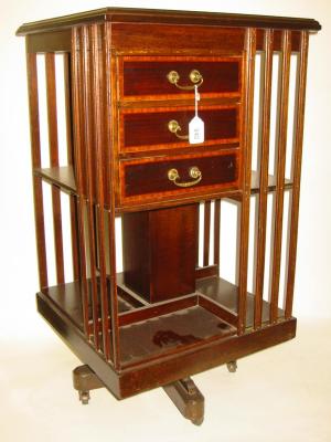 Appraisal: AN EDWARDIAN MAHOGANY REVOLVING BOOKCASE of square two tier form