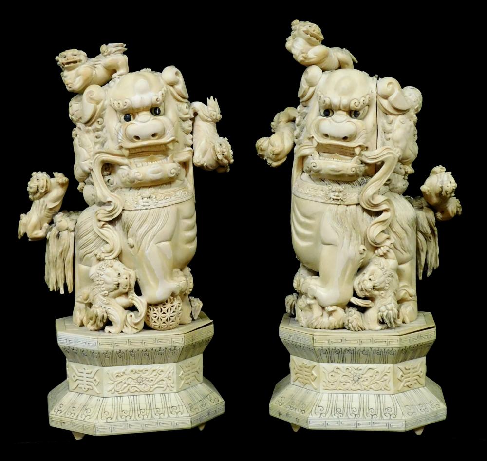 Appraisal: ASIAN Pair of carved ivory Buddhistic Lions Foo Dogs groups