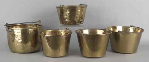 Appraisal: Five brass pots with iron swing handles largest - h