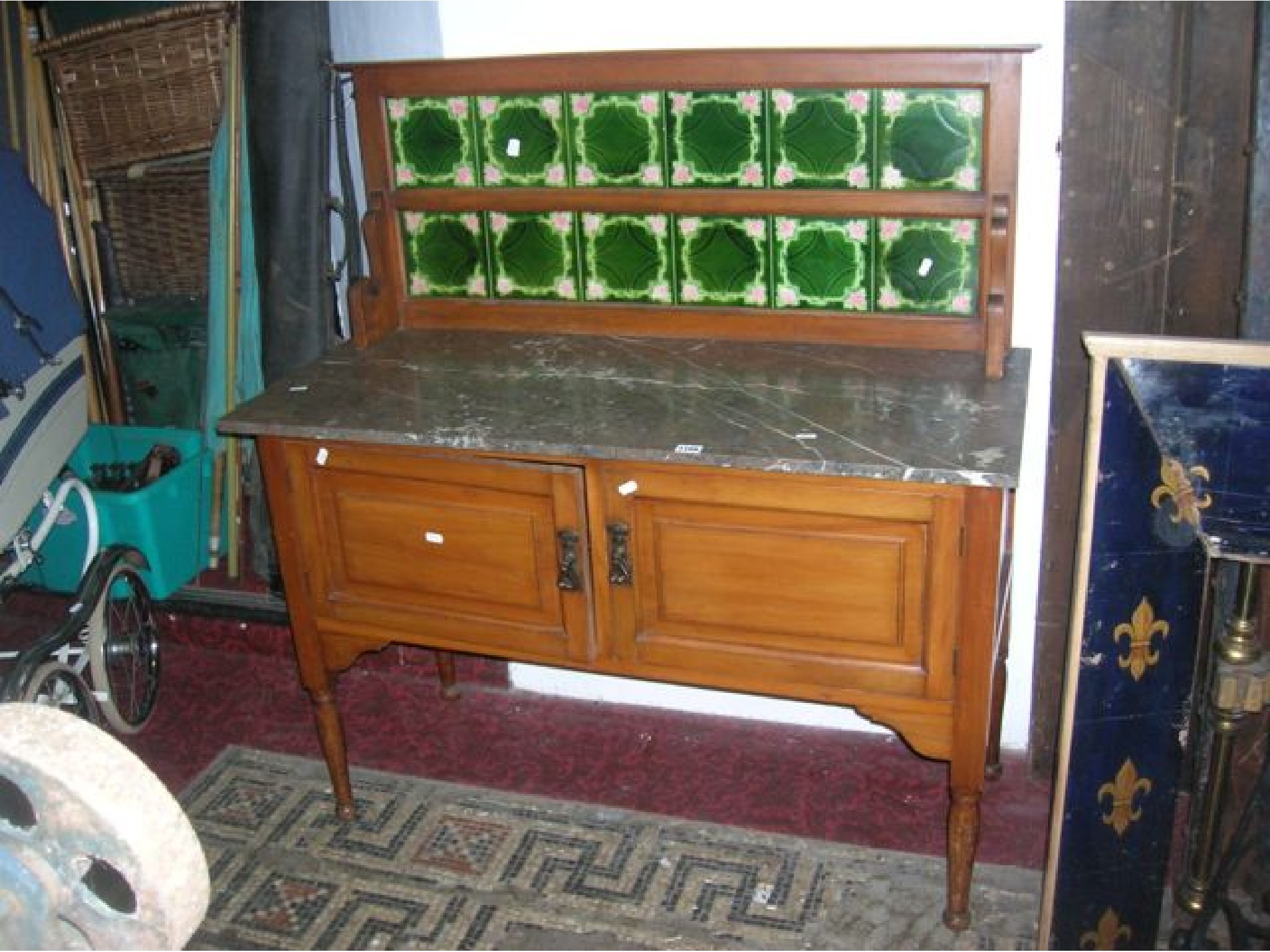 Appraisal: An Edwardian satin walnut marble top washstand with raised decorative