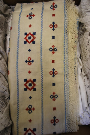 Appraisal: Blue and red cross-stitched linen tablecloth and a collection of